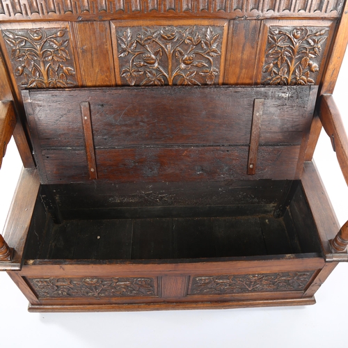 1069 - An Antique oak settle with relief carved rose design 3-panel back, rising seat and carved 2-panel fr... 