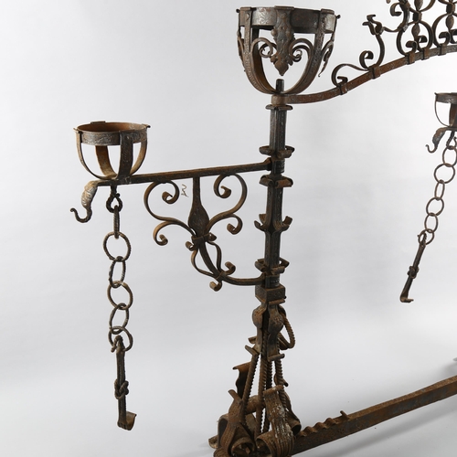 1075 - An exceptional late 17th century wrought-iron andiron for an inglenook fireplace, the joined pair to... 