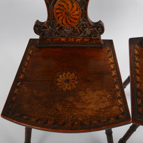 1079 - A pair of 19th century Swiss hall chairs, with ornate relief carved backs and inlaid panels, part of... 