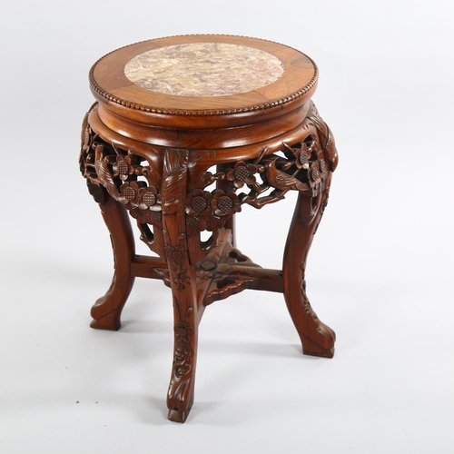 1082 - A Chinese rosewood circular occasional table, with inset marble top and carved frieze, diameter 31cm... 