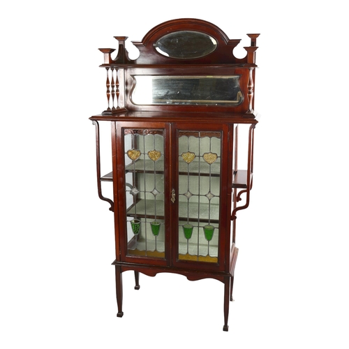 1070 - An Edwardian Art Nouveau display cabinet, with mirror inset spindled back and leadlight glazed panel... 