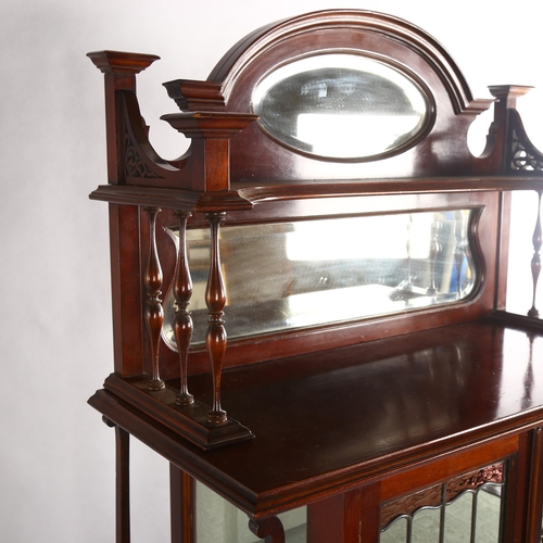 1070 - An Edwardian Art Nouveau display cabinet, with mirror inset spindled back and leadlight glazed panel... 