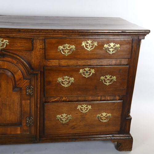 1118 - 18th century oak dresser base with arch panelled centre cupboard and 7 drawers, length 178cm, depth ... 