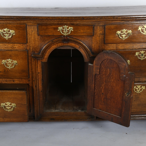 1118 - 18th century oak dresser base with arch panelled centre cupboard and 7 drawers, length 178cm, depth ... 