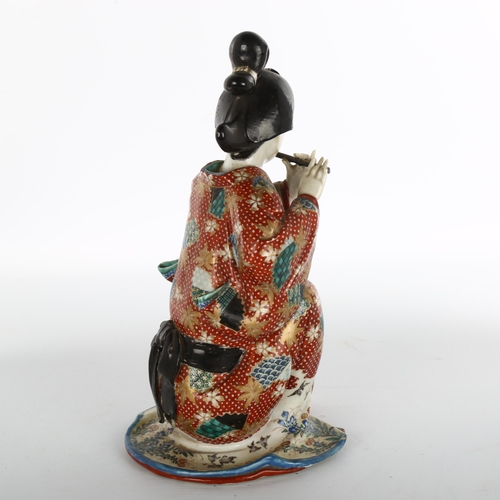 1136 - Japanese porcelain figure of a woman playing a flute, height 26cm