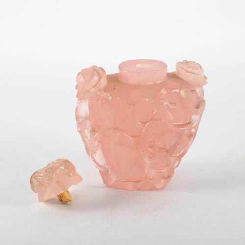 1142 - A Chinese 19th century rose quartz snuff bottle and stopper, with relief carved exotic birds and flo... 