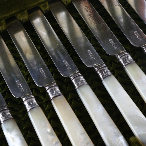 1166 - A set of hallmarked silver and mother-of-pearl handled dessert knives and forks for 12 people, in or... 