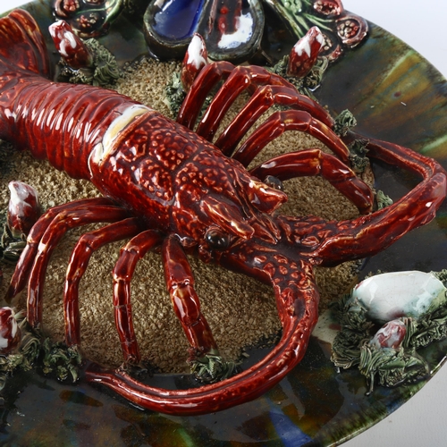 1167 - A Palissy style lobster and crustacean decorated pottery plate, indistinct impressed marks, diameter... 