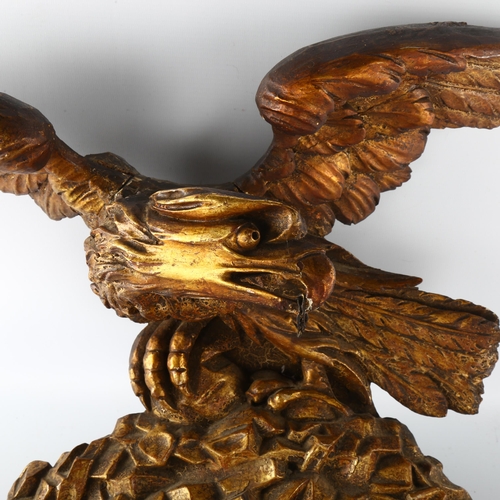 1175 - A Georgian carved giltwood eagle design pediment, wingspan 55cm