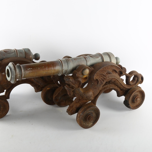 1183 - A pair of 19th century bronze-barrelled model cannons, on wheeled cast-iron dragon design bases, bar... 