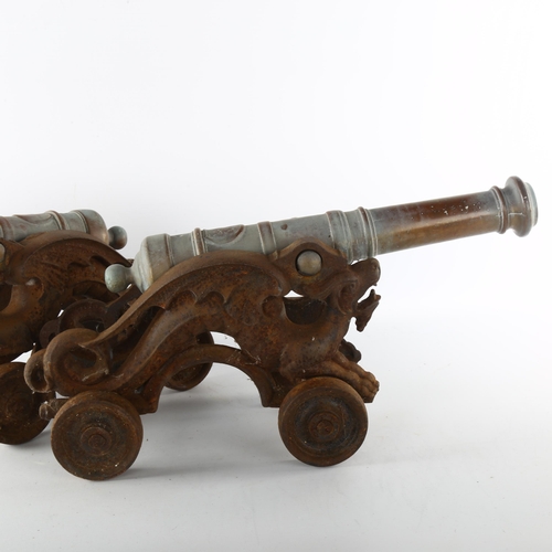 1183 - A pair of 19th century bronze-barrelled model cannons, on wheeled cast-iron dragon design bases, bar... 