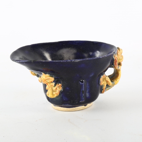 1186 - A Chinese blue and yellow glaze libation cup, with chilong dragon mounts, length 12cm