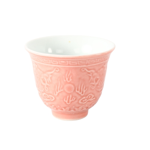 1193 - A Chinese pink glaze porcelain tea cup, with relief moulded dragon decoration, 4 character mark, hei... 