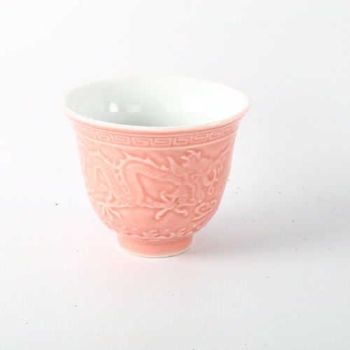 1193 - A Chinese pink glaze porcelain tea cup, with relief moulded dragon decoration, 4 character mark, hei... 