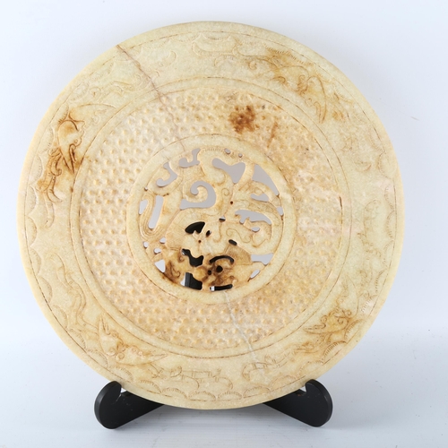 1194 - A large Chinese relief carved and pierced stone bi disc with dragon centre, diameter 31cm