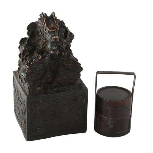 1203 - A Chinese patinated bronze desk seal with dragon mount, height 17cm, and a small Chinese bronze sect... 