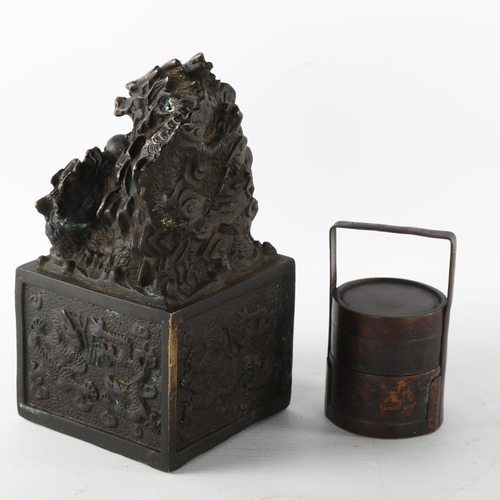 1203 - A Chinese patinated bronze desk seal with dragon mount, height 17cm, and a small Chinese bronze sect... 