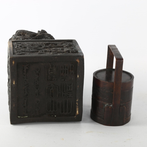 1203 - A Chinese patinated bronze desk seal with dragon mount, height 17cm, and a small Chinese bronze sect... 