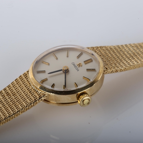 16 - OMEGA - a lady's 9ct gold mechanical bracelet watch, circa 1977, silvered dial with gilt baton hour ... 