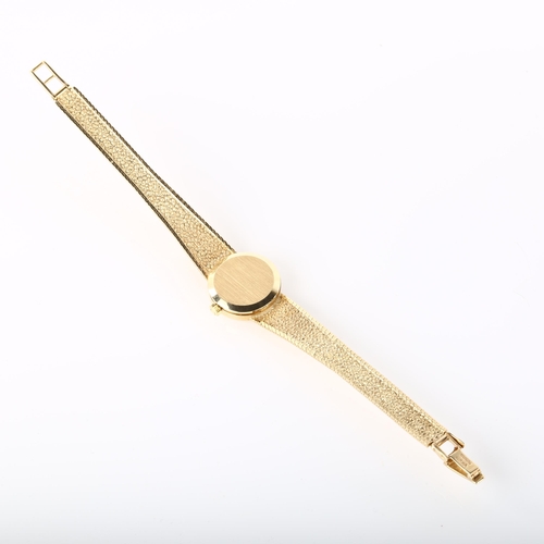 16 - OMEGA - a lady's 9ct gold mechanical bracelet watch, circa 1977, silvered dial with gilt baton hour ... 