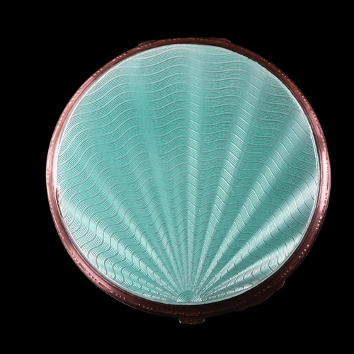 527 - An Art Deco George VI silver and green enamel compact, circular form with engine turned sunburst dec... 