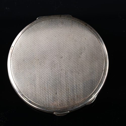 530 - An Art Deco George VI silver and bronze enamel compact, circular form with engine turned decoration,... 