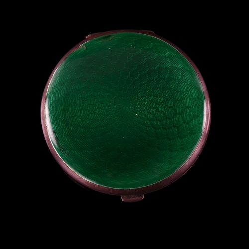 532 - An Art Deco George V silver and green enamel compact, circular form with engine turned decoration an... 