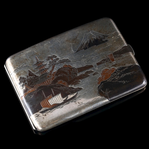 534 - A Japanese silver Damascene curved cigarette case, with outside and inside decoration depicting Moun... 