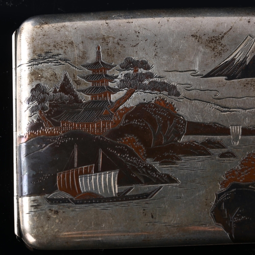 534 - A Japanese silver Damascene curved cigarette case, with outside and inside decoration depicting Moun... 