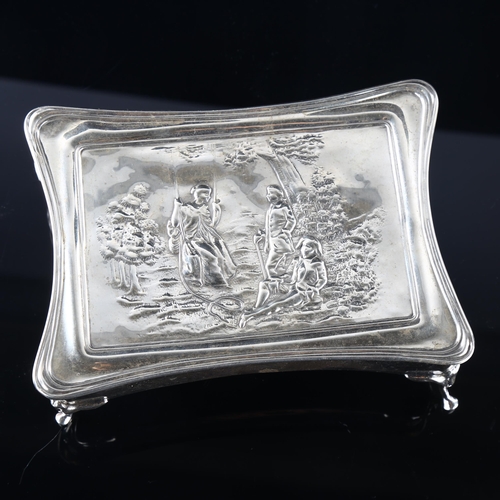 538 - A large Edwardian silver dressing table jewel box, shaped rectangular form with relief embossed figu... 