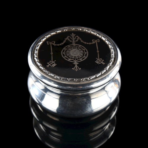 549 - An Edwardian silver and tortoiseshell dressing table powder box, circular form with silver plique in... 