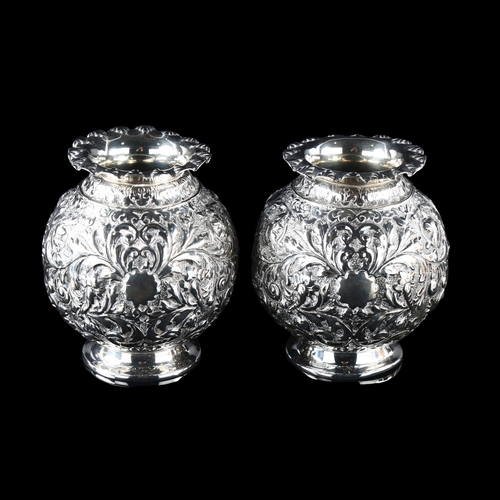 557 - A pair of Victorian silver globular vases, allover relief embossed foliate decoration, by Horace Woo... 