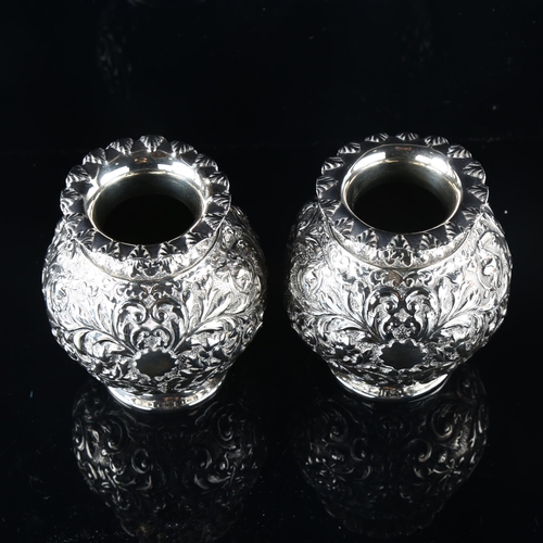 557 - A pair of Victorian silver globular vases, allover relief embossed foliate decoration, by Horace Woo... 