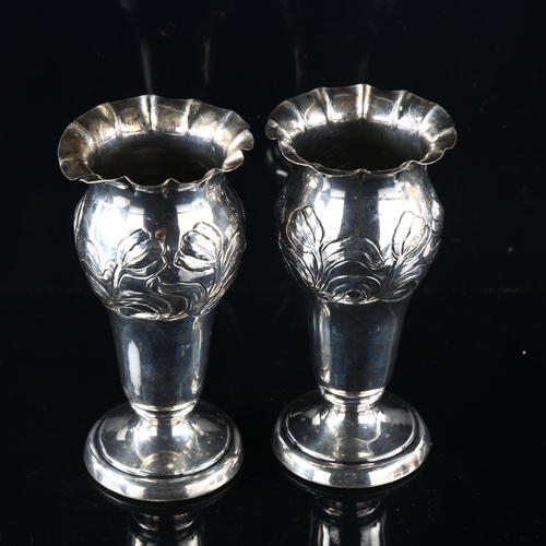 558 - A pair of late Victorian silver trumpet bud vases, fluted rims with relief embossed floral decoratio... 