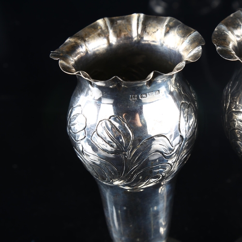 558 - A pair of late Victorian silver trumpet bud vases, fluted rims with relief embossed floral decoratio... 