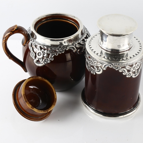 587 - An Edwardian silver-mounted stoneware pottery bachelor's teapot and tea caddy, relief embossed flora... 