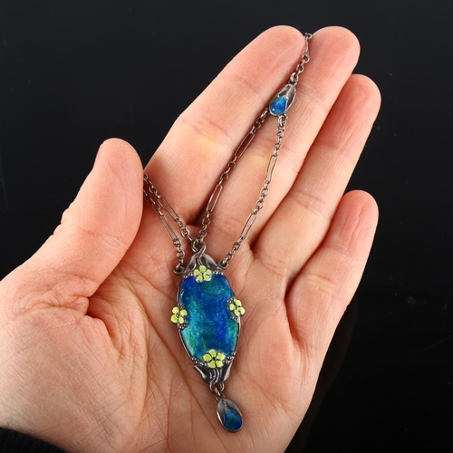 105 - MURRLE BENNETT - an Arts and Crafts silver and enamel lavaliere pendant necklace, with main peacock ... 