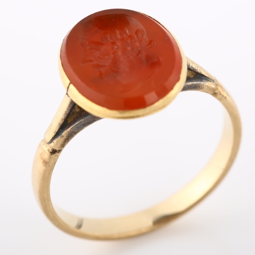 113 - An Antique carnelian ring stone, intaglio carved depicting male portrait, in unmarked gold setting, ... 