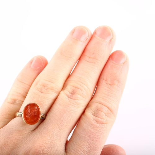 113 - An Antique carnelian ring stone, intaglio carved depicting male portrait, in unmarked gold setting, ... 