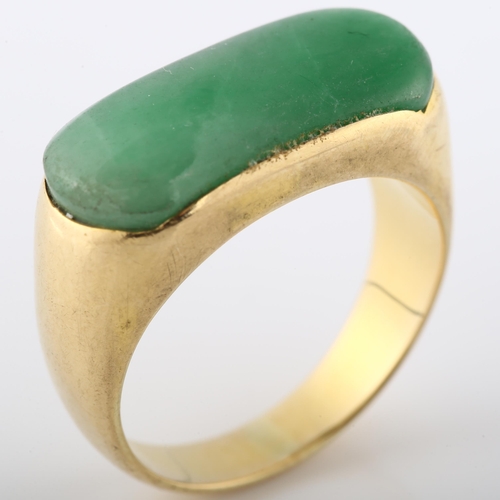 114 - A Chinese 18ct gold jade tank ring, set with oval cabochon jade, setting height 10.3mm, size S, 7.8g