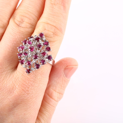 124 - A large 18ct white gold ruby and diamond cocktail ring, set with round-cut rubies and single-cut dia... 