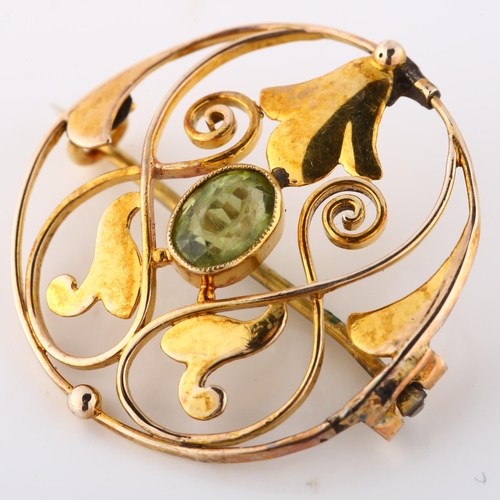 132 - MURRLE BENNETT - an Art Nouveau 9ct gold peridot openwork brooch, set with oval mixed-cut peridot, b... 