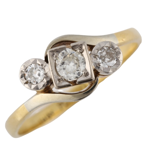 141 - An 18ct gold three stone diamond crossover ring, platinum-topped set with modern round brilliant-cut... 