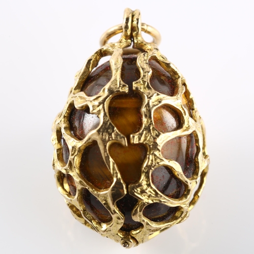 154 - A 1970s 9ct gold tigers eye egg pendant, textured naturalist frame, hallmarks London 1971, pendant h... 