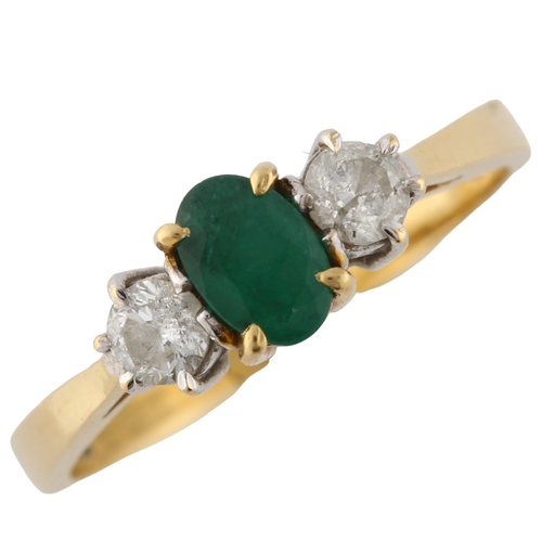 157 - An 18ct gold three stone emerald and diamond ring, set with oval mixed-cut emerald and modern round ... 