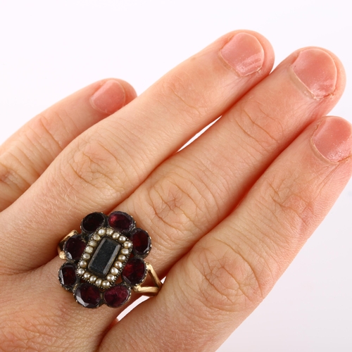 159 - A large Georgian garnet and pearl cluster memorial ring, unmarked gold closed-back settings with cen... 