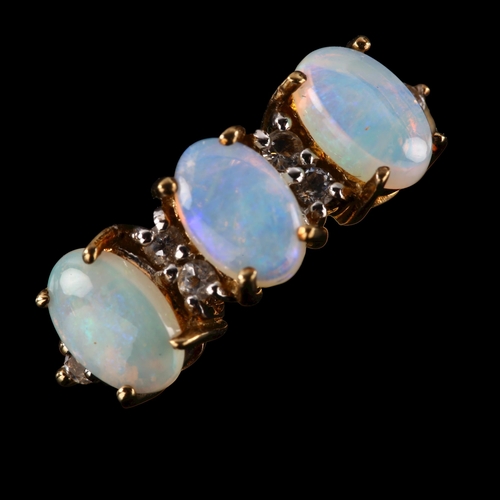 263 - A modern 9ct gold opal and cubic zirconia half hoop ring, set with oval cabochon opal and single-cut... 