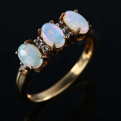 263 - A modern 9ct gold opal and cubic zirconia half hoop ring, set with oval cabochon opal and single-cut... 