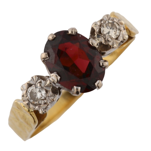 349 - An 18ct gold three stone garnet and diamond ring, set with oval and mixed-cut garnet and modern roun... 