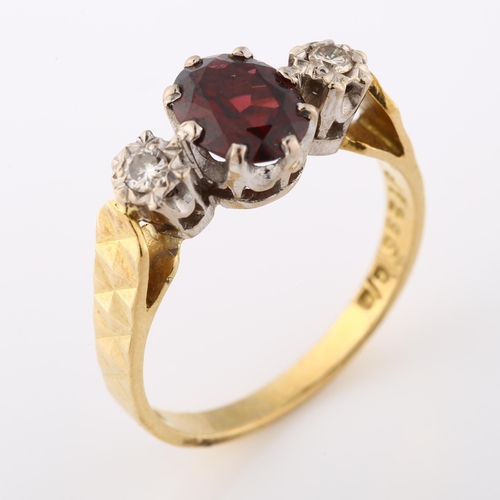 349 - An 18ct gold three stone garnet and diamond ring, set with oval and mixed-cut garnet and modern roun... 